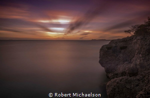 Dive Site Oil Slick in Bonaire just after sunset. by Robert Michaelson 